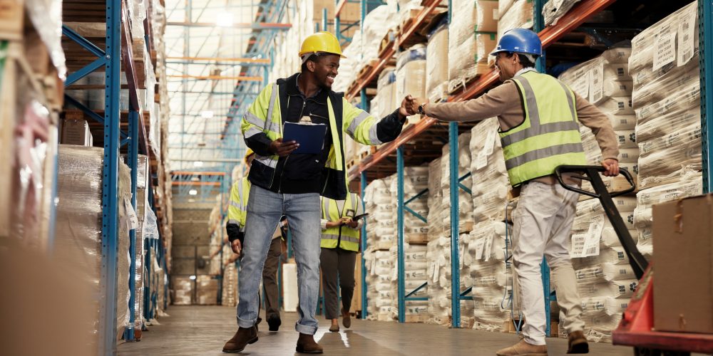 men-fist-bump-teamwork-warehouse-logistics-clipboard-greeting-by-shelf-respect-inspection-people-happy-inventory-distribution-smile-supply-chain-industrial-plant